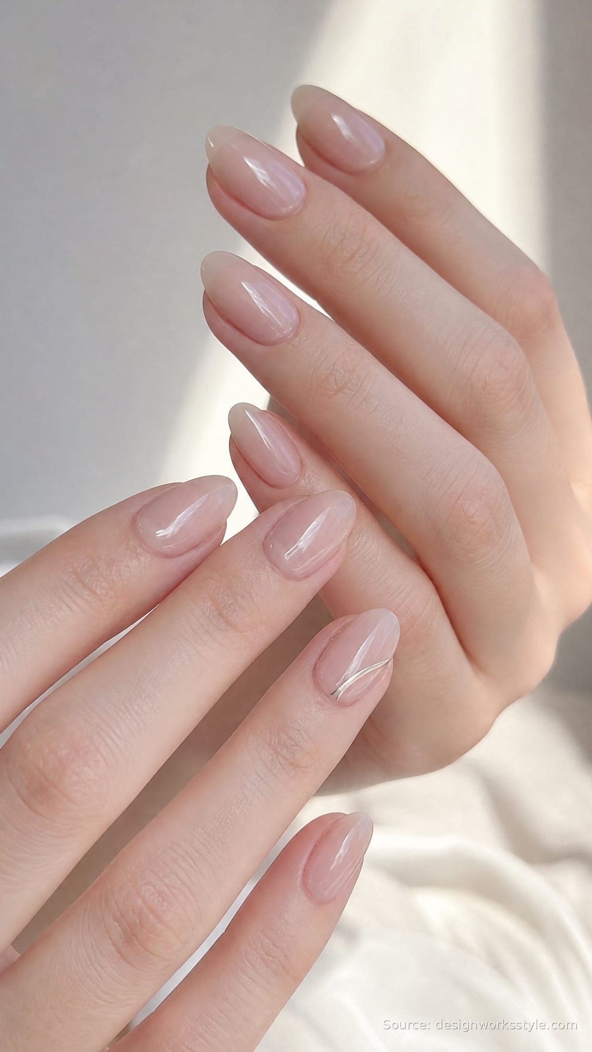 Nude almond shaped nails with glossy finish