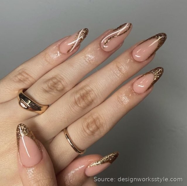 Nude nails with gold glitter French tips for New Year's Eve
