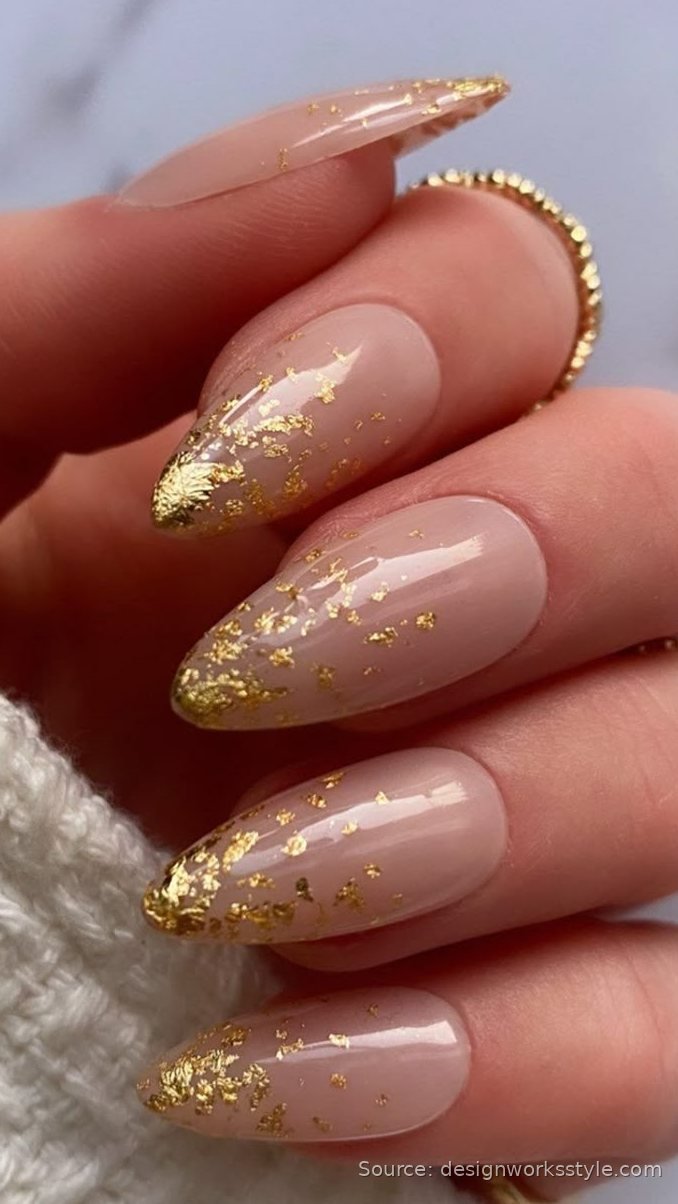 Nude November nails with gold leaf flakes on almond shape