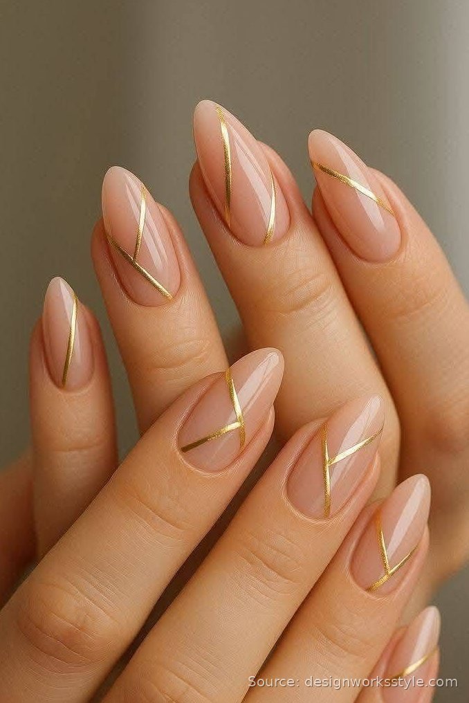 Nude almond nails with delicate gold line nail art