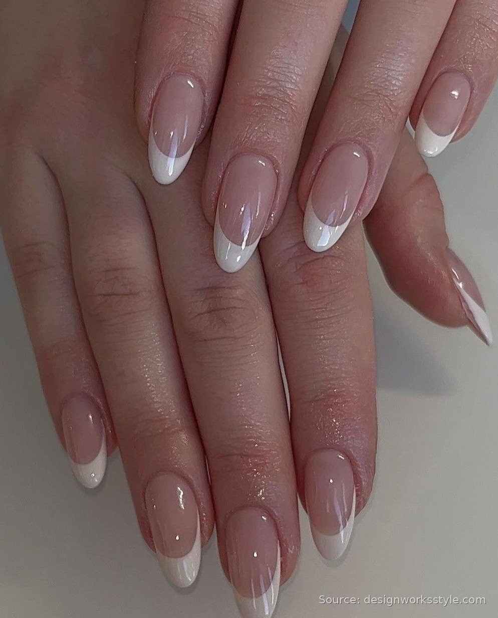 Nude French tip nails with crisp white tips on almond nails