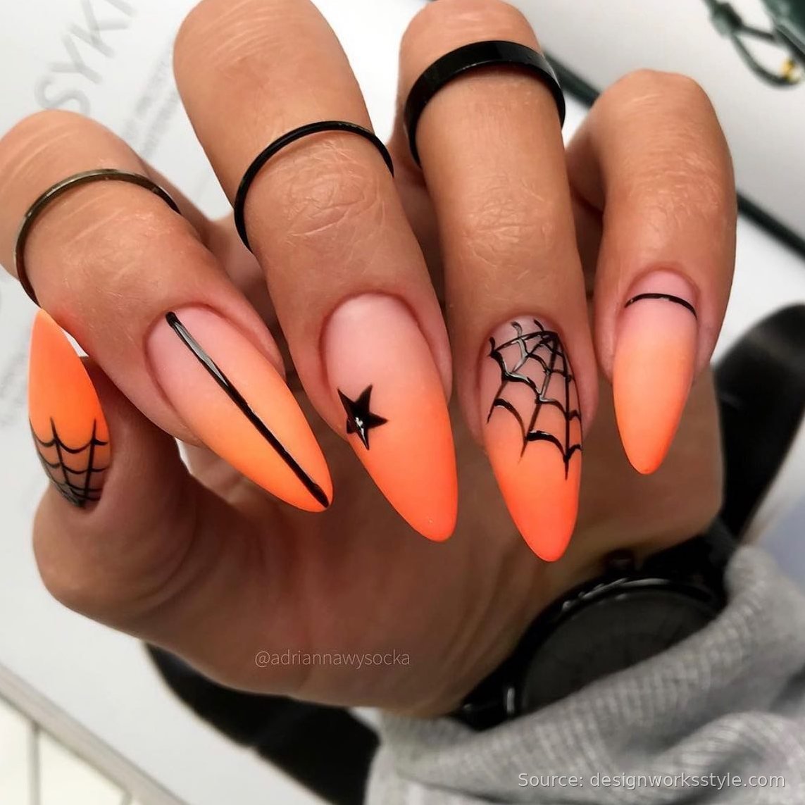 Orange ombre Halloween nails with black spiderweb and star line art