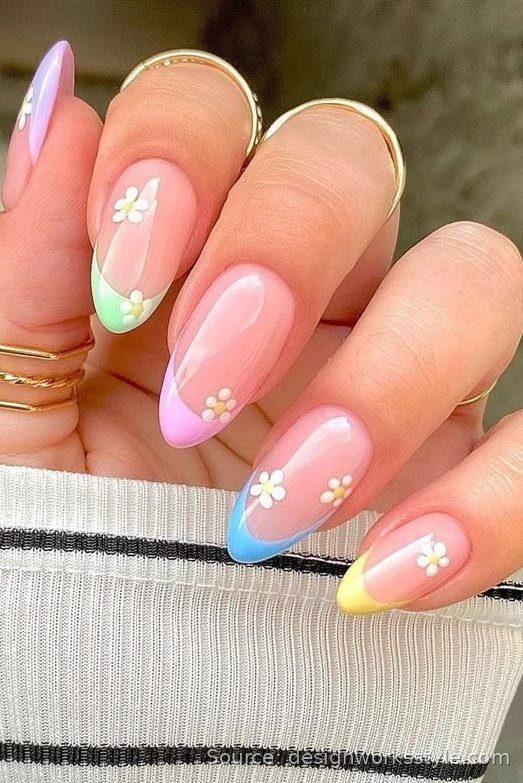 Pastel multicolor French tip nails with tiny daisy accents