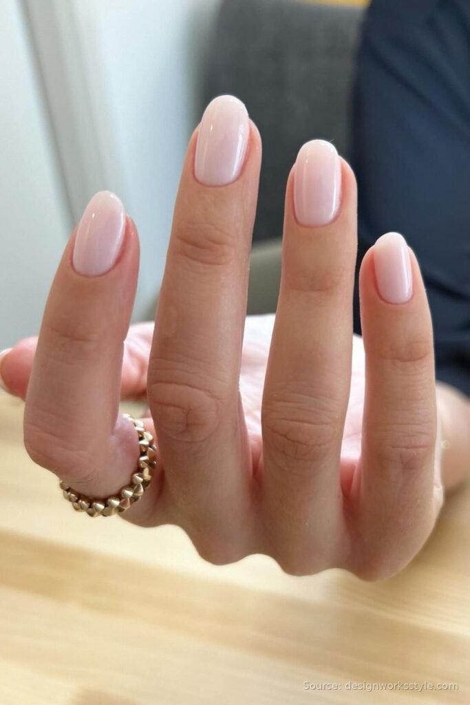 Elegant nude manicure perfectly matched to skin tone on almond nails