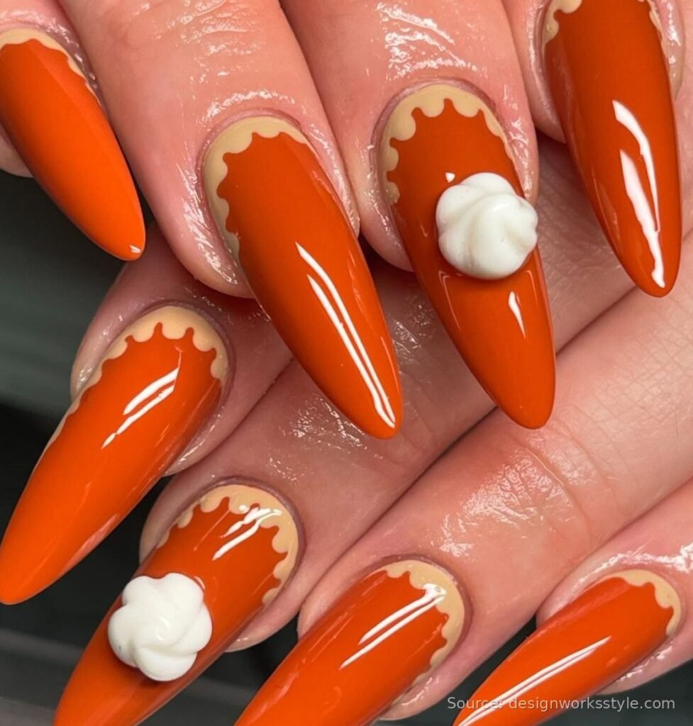 Pumpkin pie nail art with whipped cream dollops on burnt orange nails