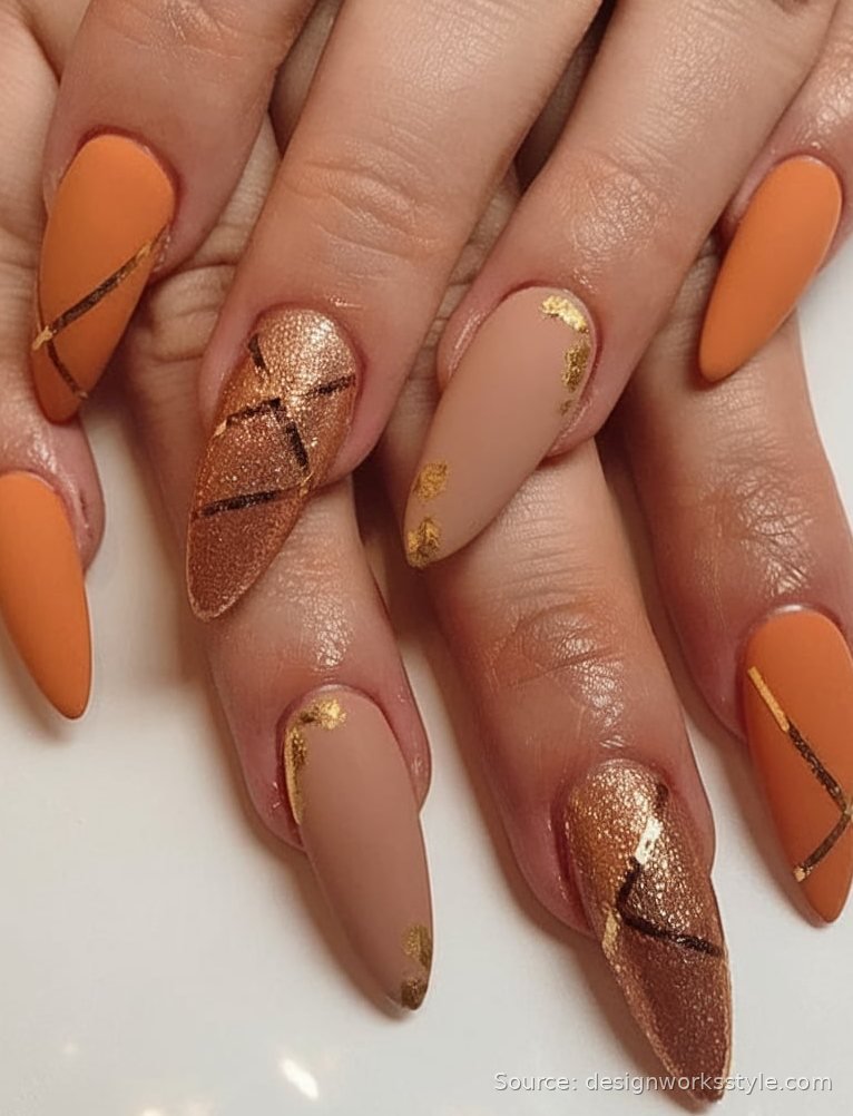 Matte pumpkin spice orange nails with caramel and gold stripe accents