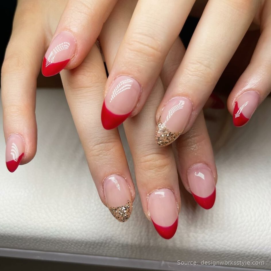 Red French tip nails with gold glitter accent tips on nude almond nails
