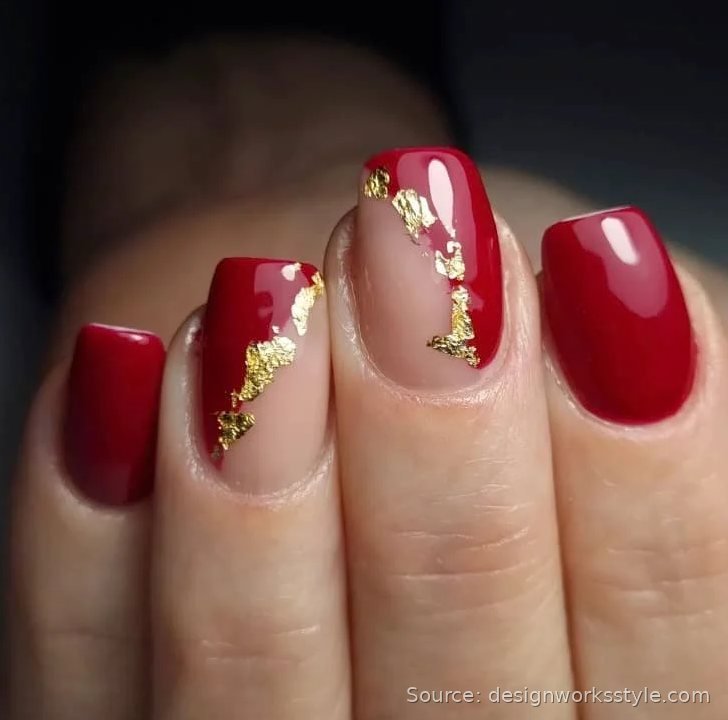 Red fall nails with gold foil accents on nude nails