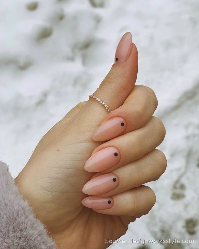Single black dot accent on nude pink almond nails