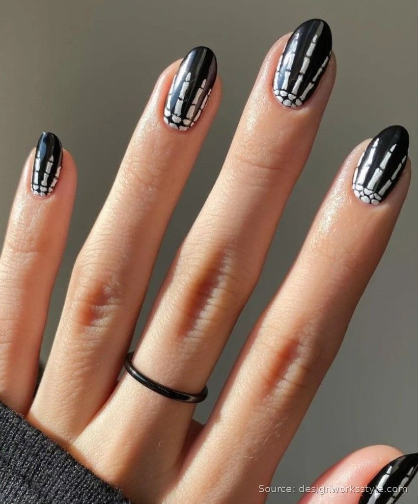 Black Halloween nails with white skeleton hand bone nail art