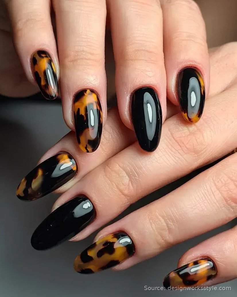 Tortoiseshell fall nails with black accent nails on almond shape