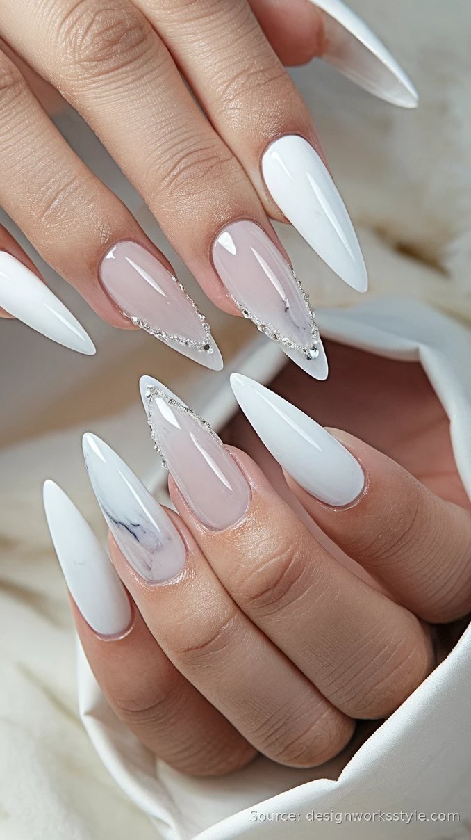 Winter white stiletto nails with marble and crystal accents
